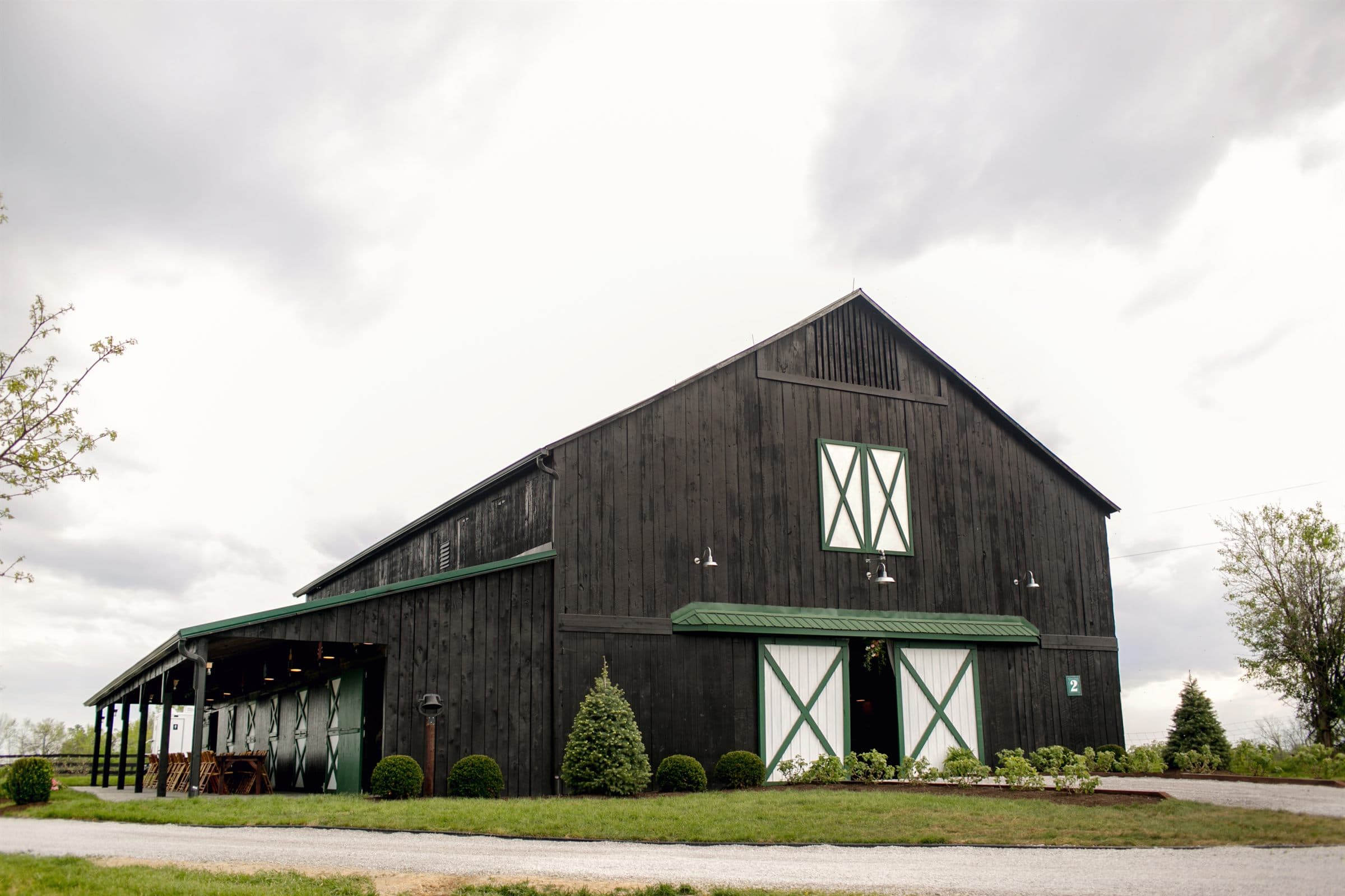 The black tobacco barn under a dramatic Kentucky sky
